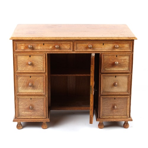 378 - Property of a deceased estate - a small Cotswold School oak kneehole desk attributed to Peter Waals ... 