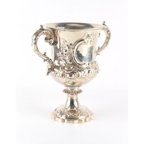 263 - Property of a gentleman - a Victorian silver two handled pedestal cup, with repousse floral & 'C'-sc... 