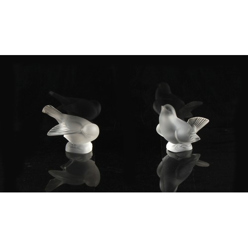 314 - Property of a lady - Lalique - a pair of Lalique frosted glass models of birds, in different poses, ... 