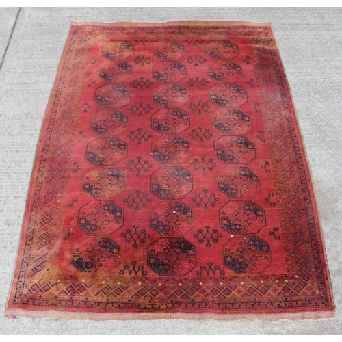 284 - Property of a deceased estate - a Turkoman carpet with three rows of eight octagonal 'elephant foot'... 