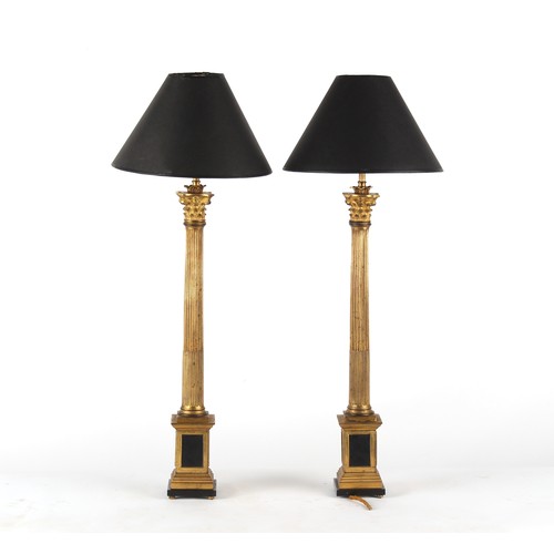 289 - Property of a lady - a pair of gilt bronze Corinthian column table lamps, with shades, one bun foot ... 