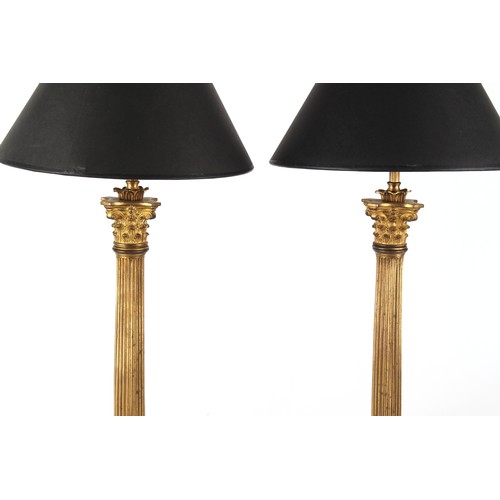 289 - Property of a lady - a pair of gilt bronze Corinthian column table lamps, with shades, one bun foot ... 