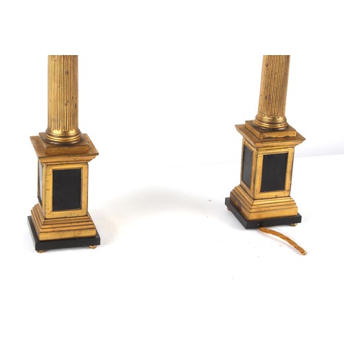 289 - Property of a lady - a pair of gilt bronze Corinthian column table lamps, with shades, one bun foot ... 