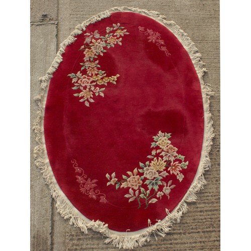 291 - Property of a deceased estate - a modern Chinese hand-knotted wool oval rug with burgundy ground, ap... 