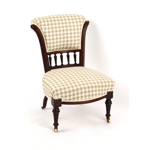 297 - Property of a lady - a late Victorian walnut nursing chair, re-upholstered, on turned front legs & w... 