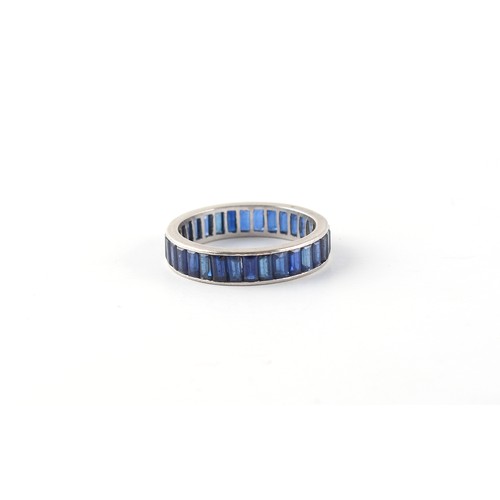 272 - Property of a lady - an unmarked platinum sapphire eternity ring, with baguette cut sapphires, appro... 