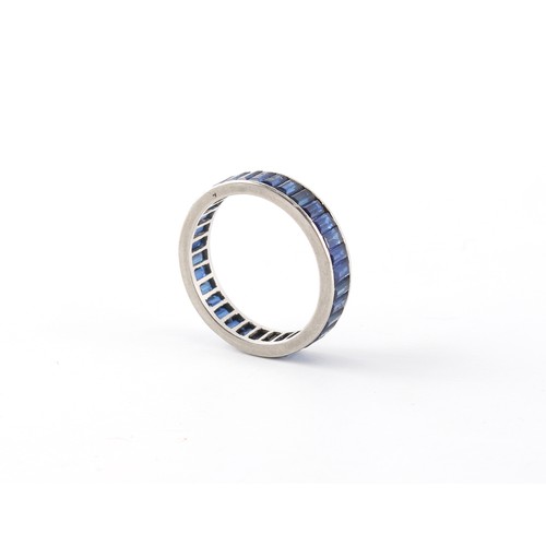 272 - Property of a lady - an unmarked platinum sapphire eternity ring, with baguette cut sapphires, appro... 