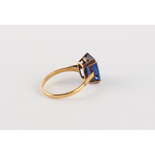 87 - A large yellow gold emerald cut synthetic sapphire ring, the stone measuring approximately 14 by 10 ... 