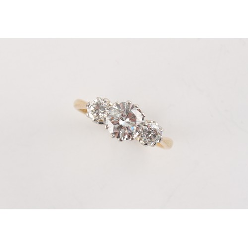 97 - An 18ct yellow gold diamond three stone ring, the centre round brilliant cut diamond weighing approx... 