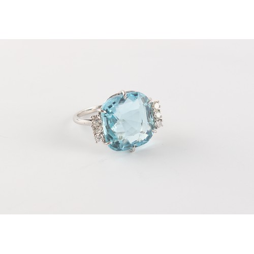 142 - A large aquamarine & diamond ring, set in unmarked white gold, the cushion cut aquamarine weighing a... 