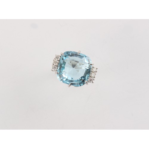 142 - A large aquamarine & diamond ring, set in unmarked white gold, the cushion cut aquamarine weighing a... 