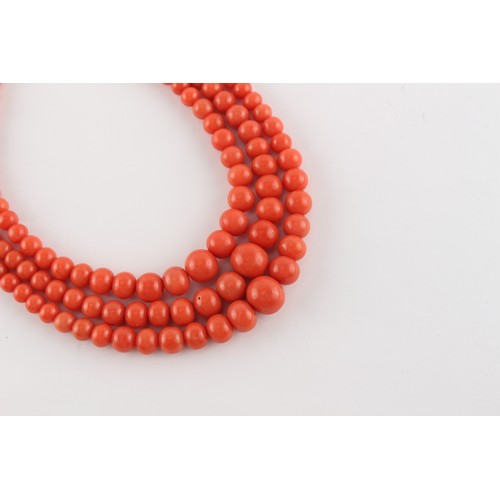 70 - A coral graduated bead three strand necklace, the largest bead (excluding clasp) measuring approxima... 