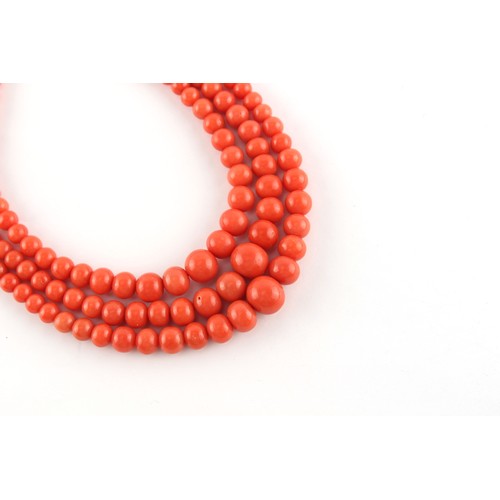 70 - A coral graduated bead three strand necklace, the largest bead (excluding clasp) measuring approxima... 