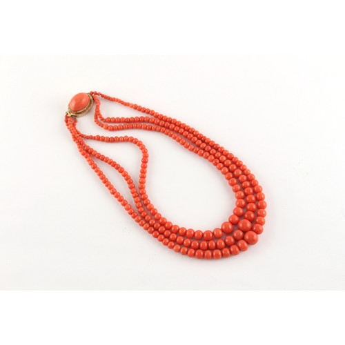 70 - A coral graduated bead three strand necklace, the largest bead (excluding clasp) measuring approxima... 