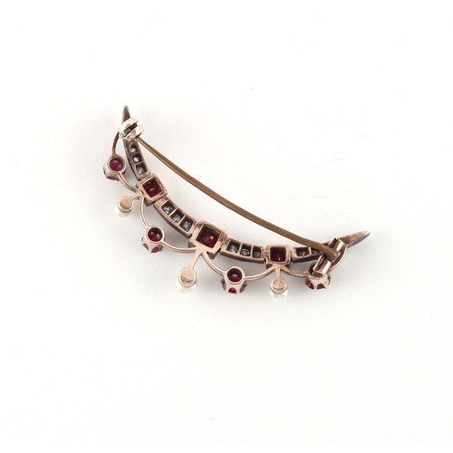 147 - An early 20th century ruby diamond & seed pearl festoon crescent brooch, the estimated total ruby we... 