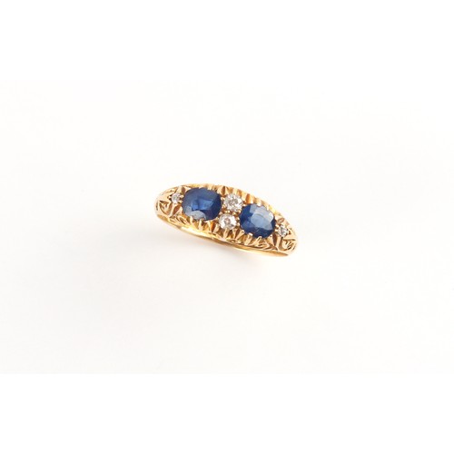 113 - Property of a lady - an early 20th century 18ct gold sapphire & diamond ring, the two oval cushion c... 