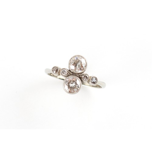 218 - Property of a lady - an early 20th century platinum diamond ring, the two larger round brilliant cut... 