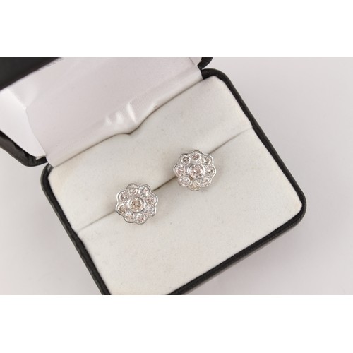 60 - A pair of white gold diamond flowerhead stud earrings, the estimated total diamond weight 2.0 carats... 