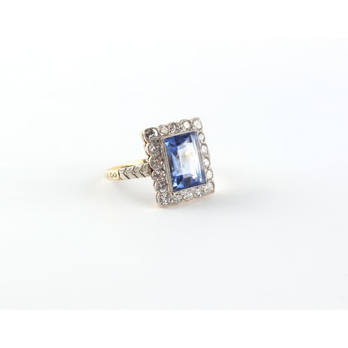 88 - A Continental yellow gold sapphire & diamond ring, the rectangular cut sapphire weighing approximate... 