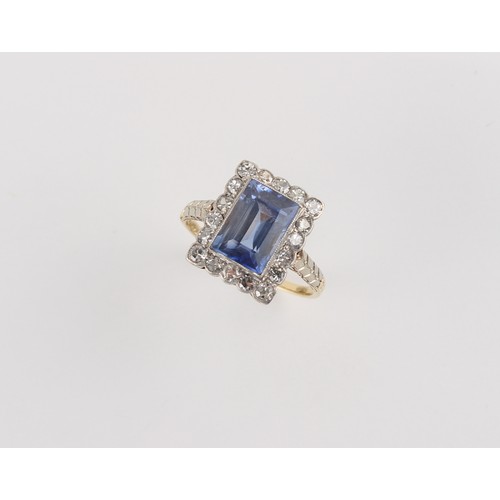 88 - A Continental yellow gold sapphire & diamond ring, the rectangular cut sapphire weighing approximate... 