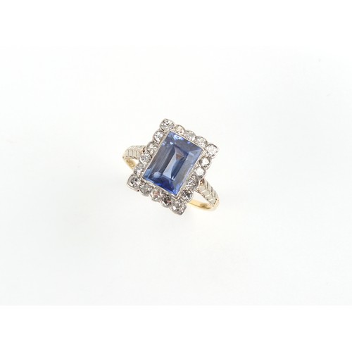 88 - A Continental yellow gold sapphire & diamond ring, the rectangular cut sapphire weighing approximate... 