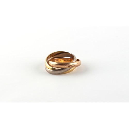 160A - Property of a lady - Cartier - a set of three 18ct white, yellow & rose gold interlocking rings or T... 