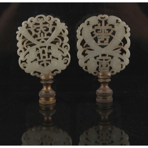 72 - Property of a lady - two similar early 20th century Chinese carved white jade pendant plaques adapte... 