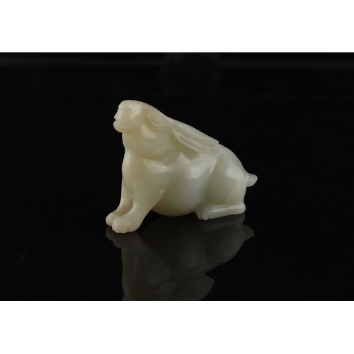 12 - A Chinese carved white jade model of a Rabbit, probably 20th century, 3ins. (7.6cms.) long, 2.3ins. ... 