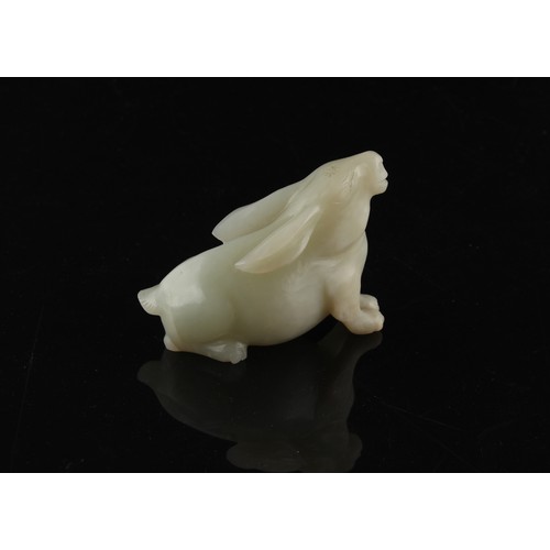 12 - A Chinese carved white jade model of a Rabbit, probably 20th century, 3ins. (7.6cms.) long, 2.3ins. ... 