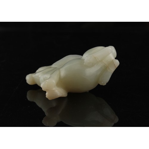 12 - A Chinese carved white jade model of a Rabbit, probably 20th century, 3ins. (7.6cms.) long, 2.3ins. ... 