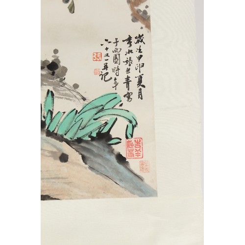 61 - A Chinese scroll painting on paper depicting flowers and rockwork, signed with calligraphy and seven... 