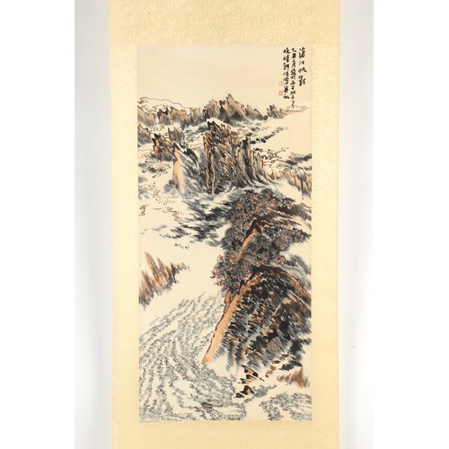 63 - A Chinese scroll painting on paper depicting a mountainous landscape, signed with calligraphy and tw... 