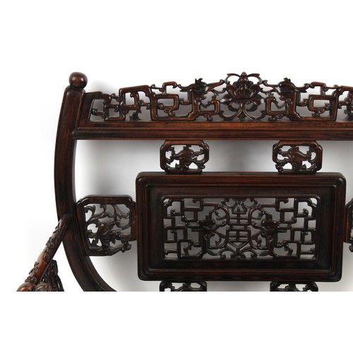 67 - A late 19th century Chinese carved hongmu armchair, the arms carved in relief with prunus, with drag... 