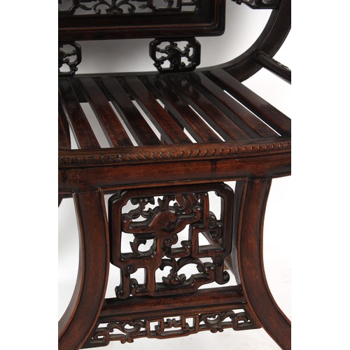 67 - A late 19th century Chinese carved hongmu armchair, the arms carved in relief with prunus, with drag... 