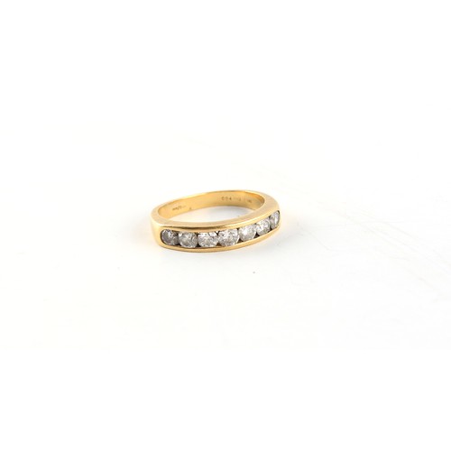 48 - Property of a lady - an 18ct yellow gold ring set with a row of seven round brilliant cut diamonds, ... 