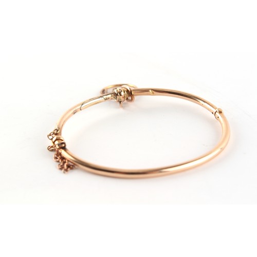 105 - Property of a lady - a Victorian 15ct gold hinged bangle with unmarked gold (tests 9ct) 1891 pendant... 