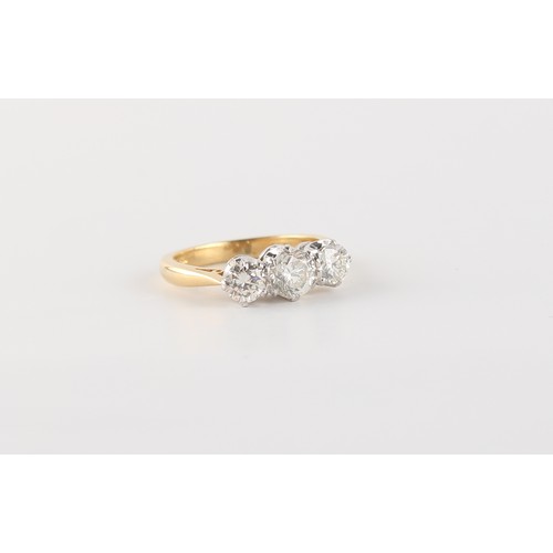 26 - An 18ct yellow gold diamond three stone ring, the estimated total diamond weight 1.05 carats, size I... 