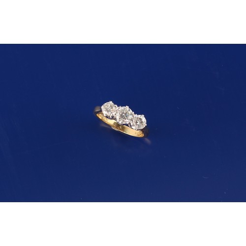 26 - An 18ct yellow gold diamond three stone ring, the estimated total diamond weight 1.05 carats, size I... 