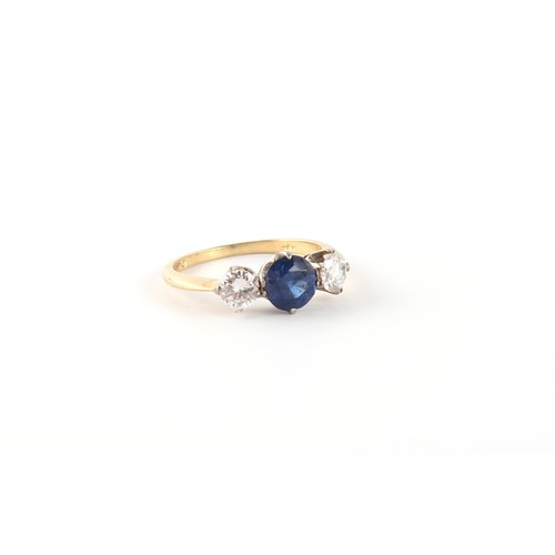 29 - An 18ct yellow gold sapphire & diamond three stone ring, the centre round cut sapphire weighing appr... 