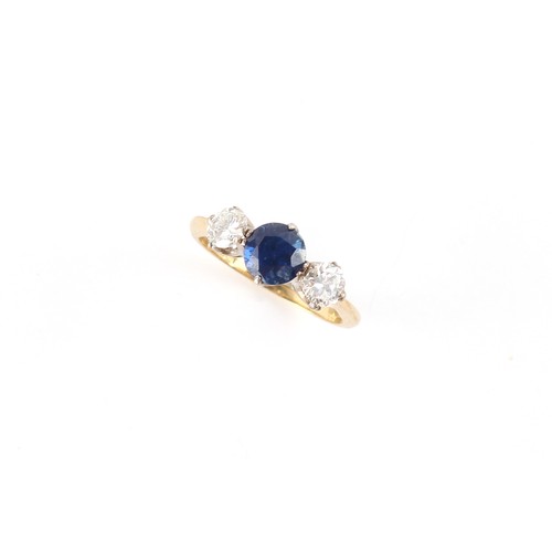 29 - An 18ct yellow gold sapphire & diamond three stone ring, the centre round cut sapphire weighing appr... 