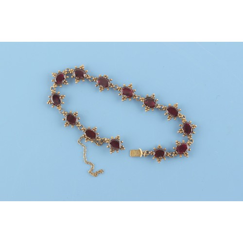 31 - An early 19th century late Georgian yellow gold (tests 18ct) oval cut garnet bracelet, with closed b... 