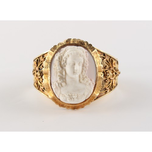 35 - A good late 19th century three colour gold (tests 14ct) hinged bangle set with a carved shell cameo ... 