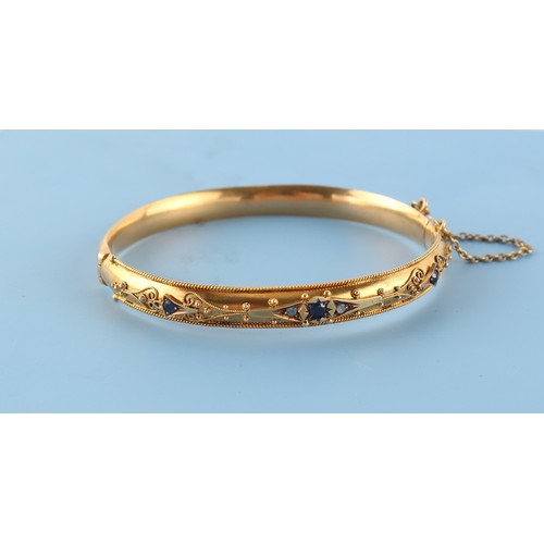 23 - A Victorian yellow gold (tests 15ct) hinged bangle set with sapphires & diamonds, with safety chain,... 