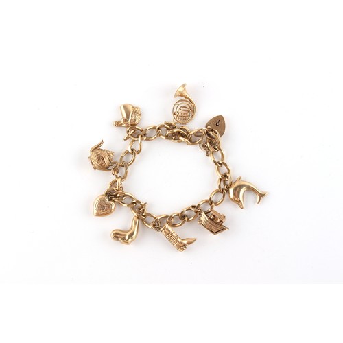 43 - Property of a lady - a 9ct gold charm bracelet with eight 9ct gold charms including a French horn, w... 