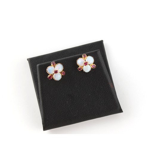 46 - A pair of unmarked yellow gold oval opal & ruby flowerhead stud earrings, each approximately 11mm ac... 