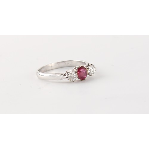 58 - An 18ct white gold ruby & diamond three stone ring, the oval cushion cut ruby weighing approximately... 