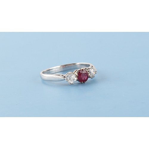 58 - An 18ct white gold ruby & diamond three stone ring, the oval cushion cut ruby weighing approximately... 