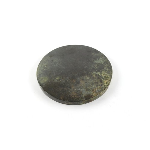 187 - Property of a lady - a Chinese bronze mirror, in the Tang style, 4.4ins. (11.2cms.) diameter.