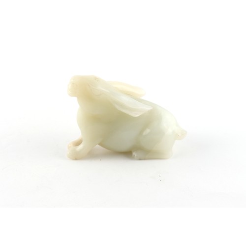 186 - A Chinese carved white jade model of a Rabbit, probably 20th century, 3ins. (7.6cms.) long, 2.3ins. ... 