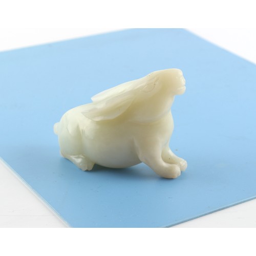 186 - A Chinese carved white jade model of a Rabbit, probably 20th century, 3ins. (7.6cms.) long, 2.3ins. ... 